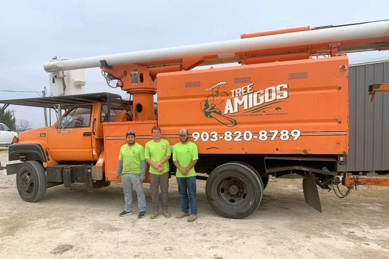 The crew of Tree Amigos standing in front of their truck.